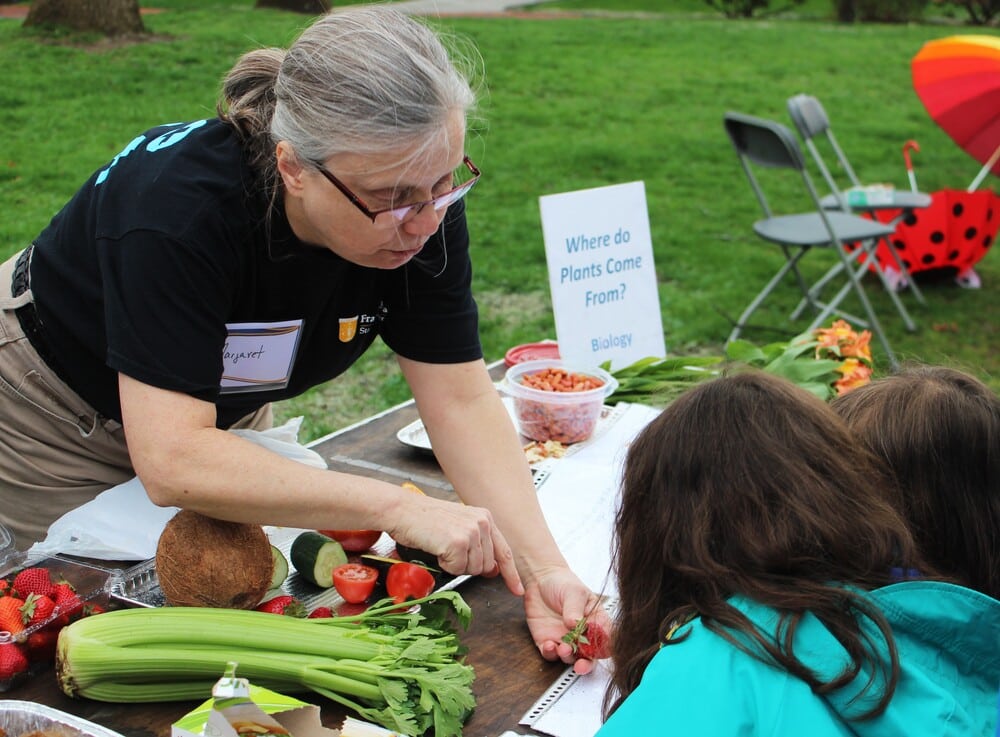 Science on State Street event with a plant activity for children led by an instructor